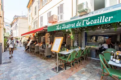 a restaurant with tables and chairs on a street at C11 - 1 BDR Rue Meynadier 5min Palais Festivals & Sea - AC in Cannes