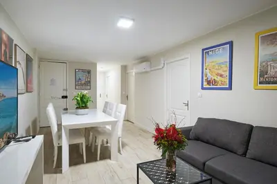a living room with a couch and a table at Apparthotel des Congrès et Festivals in Cannes