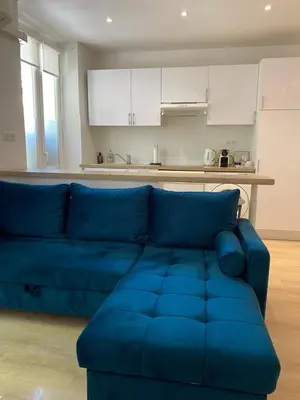 a bedroom with a large bed with white and green pillows at 2 pièces - Croisette et Plages à 10 mn à pieds in Cannes