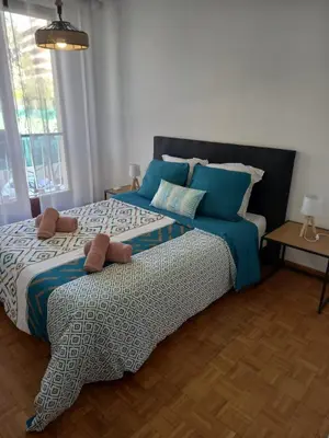 a bedroom with a large bed with blue pillows at +++++ brand new flat 4 persons near Hotel Martinez, center and Palais des festivals +++++ in Cannes