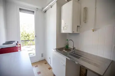 a white kitchen with a sink and a window at +++++ brand new flat 4 persons near Hotel Martinez, center and Palais des festivals +++++ in Cannes