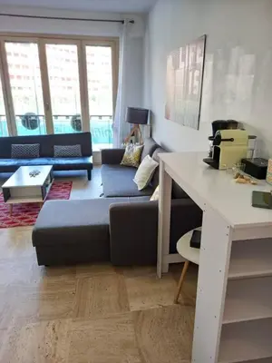 a living room with a couch and a table at +++++ brand new flat 4 persons near Hotel Martinez, center and Palais des festivals +++++ in Cannes