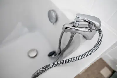 a shower hose is attached to a bathtub at +++++ brand new flat 4 persons near Hotel Martinez, center and Palais des festivals +++++ in Cannes