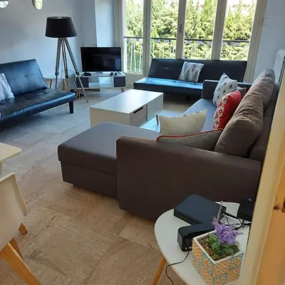 a living room with a couch and a table at +++++ brand new flat 4 persons near Hotel Martinez, center and Palais des festivals +++++ in Cannes