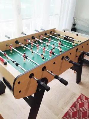 a wooden foosball table with a foos ball at +++++ brand new flat 4 persons near Hotel Martinez, center and Palais des festivals +++++ in Cannes