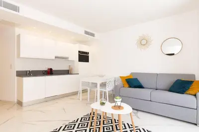 a living room with a couch and a table at Brand new 2 bedrooms next to Croisette ! in Cannes