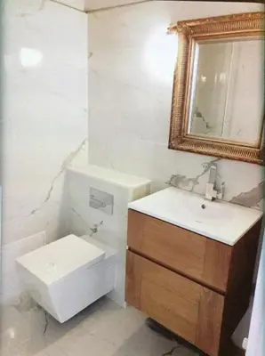 a bathroom with a sink and a toilet and a mirror at Cannes Croisette Majestic Miramar in Cannes