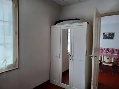 a white cabinet in a room with a window at Appartement Cannes à quelques pas de la mer, de la Croisette et du Palais des Festivals in Cannes