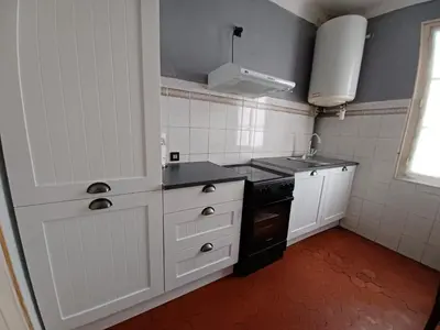 a small kitchen with white cabinets and a sink at Appartement Cannes à quelques pas de la mer, de la Croisette et du Palais des Festivals in Cannes