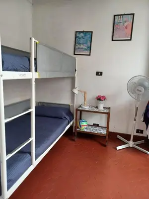 a room with two bunk beds and a table with a fan at Appartement Cannes à quelques pas de la mer, de la Croisette et du Palais des Festivals in Cannes