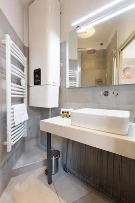 a bathroom with a sink and a mirror at Astoux YourHostHelper in Cannes