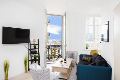 a living room with a blue couch and chairs at Astoux YourHostHelper in Cannes