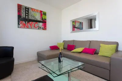 a living room with a couch and a glass table at COTE PORT in Cannes