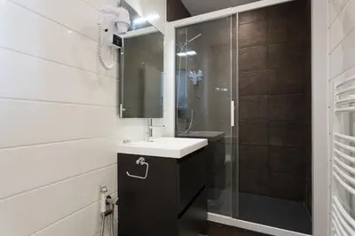a bathroom with a sink and a shower at COTE PORT in Cannes