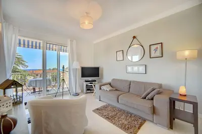 a living room with a couch and a tv at IMMOGROOM - Close beaches- Beautiful terrace - Seaview - CONGRESSBEACHES in Cannes