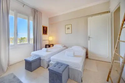 a room with two beds and a window at IMMOGROOM - Close beaches- Beautiful terrace - Seaview - CONGRESSBEACHES in Cannes