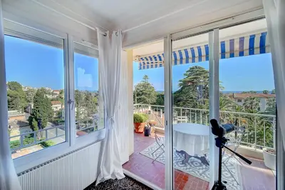 a room with a balcony with large windows at IMMOGROOM - Close beaches- Beautiful terrace - Seaview - CONGRESSBEACHES in Cannes