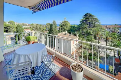 a balcony with a table and chairs on a balcony at IMMOGROOM - Close beaches- Beautiful terrace - Seaview - CONGRESSBEACHES in Cannes