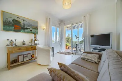 a living room with a couch and a flat screen tv at IMMOGROOM - Close beaches- Beautiful terrace - Seaview - CONGRESSBEACHES in Cannes