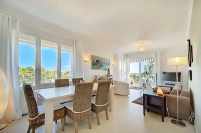 a living room with a dining room table and chairs at IMMOGROOM - Close beaches- Beautiful terrace - Seaview - CONGRESSBEACHES in Cannes