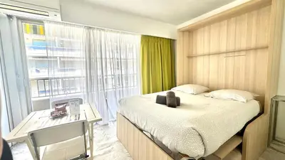 a bedroom with a bed and a desk and a window at Branly 3, by Welcome to Cannes in Cannes