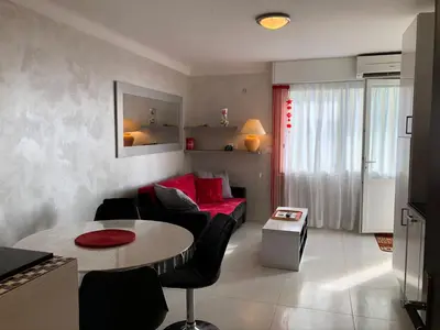 a living room with a couch and a table at Cannes Les Pins in Cannes