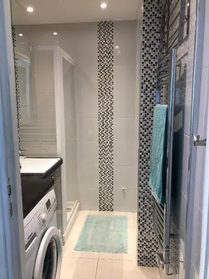a bathroom with a shower and a sink and a washing machine at Cannes Les Pins in Cannes