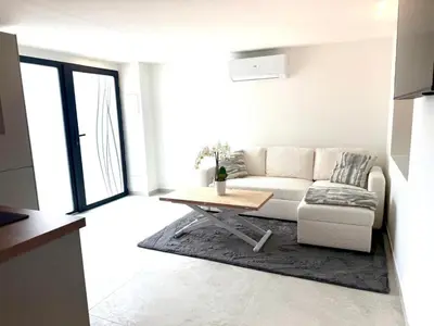 a living room with a couch and a table at Appartment Jacuzzi in Cannes in Cannes