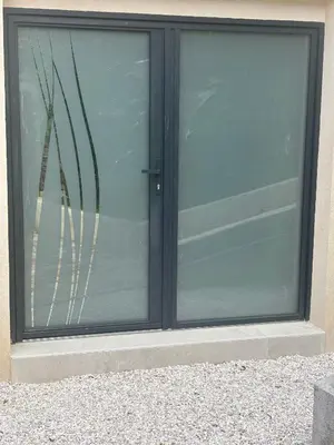 a sliding glass door with a window on a building at Appartment Jacuzzi in Cannes in Cannes
