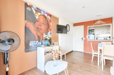 a living room with a large movie poster on the wall at Résidence Cannes Villa Francia - maeva Home - Appartement 2 pièces 6 personnes avec vue mer - Sélection - super Home MAE-3641 in Cannes