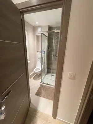 a bathroom with a glass door and a toilet at RenTcik in Cannes