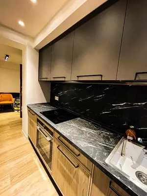 a kitchen with a black counter top and a sink at RenTcik in Cannes
