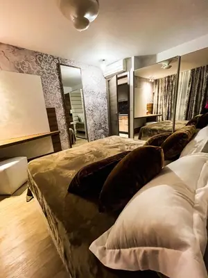a bedroom with two beds with pillows and a mirror at RenTcik in Cannes