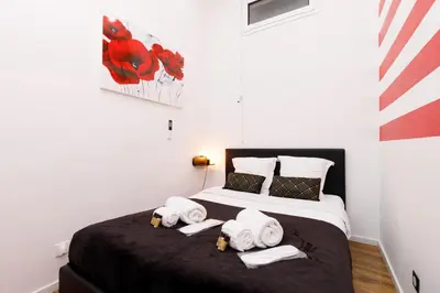 a bedroom with a bed with towels on it at Little Garden YourHostHelper in Cannes
