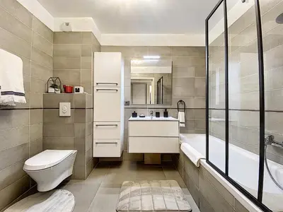 a bathroom with a toilet and a sink and a tub at Apartment Palm Beach with a nice swimming pool in Cannes