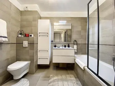 a bathroom with a toilet and a sink and a tub at Apartment Palm Beach with a nice swimming pool in Cannes