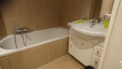 a bathroom with a bath tub and a sink at Nicolas 2 in Cannes