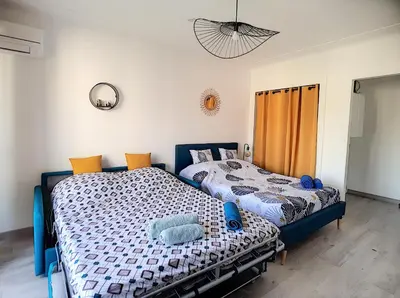 two beds sitting next to each other in a bedroom at ROOFTOP#PLAGES#APERCU MER#CLIM#Festival in Cannes