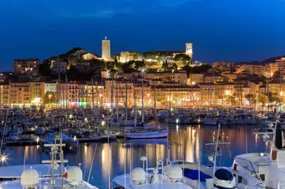 a harbor with boats and a city at night at ROOFTOP#PLAGES#APERCU MER#CLIM#Festival in Cannes