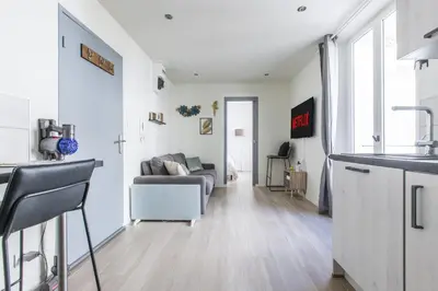 a kitchen and living room with a couch at LB Vacation Rentals I Cute Affordable 1-Br Minutes From Cannes Center in Cannes