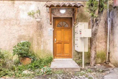 a wooden door of a building with a refrigerator at LB Vacation Rentals I Cute Affordable 1-Br Minutes From Cannes Center in Cannes