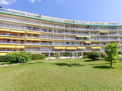 an apartment building with a lawn in front of it at Apartment Les Pervenches by Interhome in Cannes
