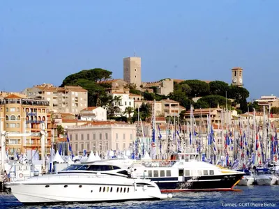 two boats are docked in a harbor with a city at Apartment Les Pervenches by Interhome in Cannes
