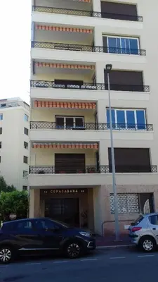 a black car parked in front of a building at COPACABANA appartement 2 chambres in Cannes