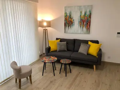 a living room with a couch and a table at Brand new studio in the heart of Cannes in Cannes