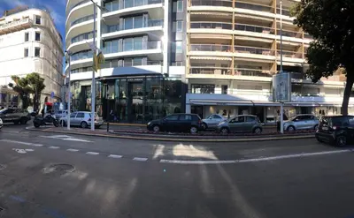 a city street with cars parked in front of a building at Brand new studio in the heart of Cannes in Cannes