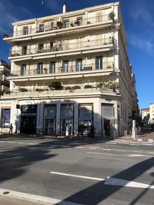 a large white building on the corner of a street at Brand new studio in the heart of Cannes in Cannes
