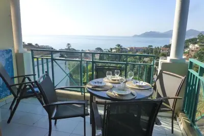 a table on a balcony with a view of the ocean at Sea views and beautiful pool in Cannes