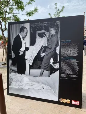 a black and white photo of a man and woman cutting a dress at T2 proximité MIPIM in Cannes