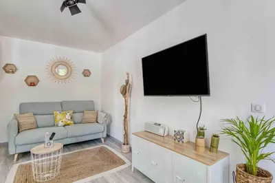 a living room with a couch and a flat screen tv at T2 proximité MIPIM in Cannes